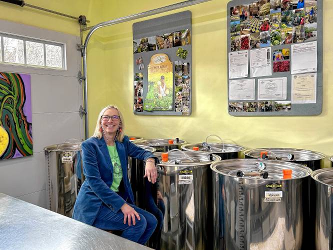 Stephanie Zydenbos, owner of Micro Mama’s sits next to the fermentation tanks