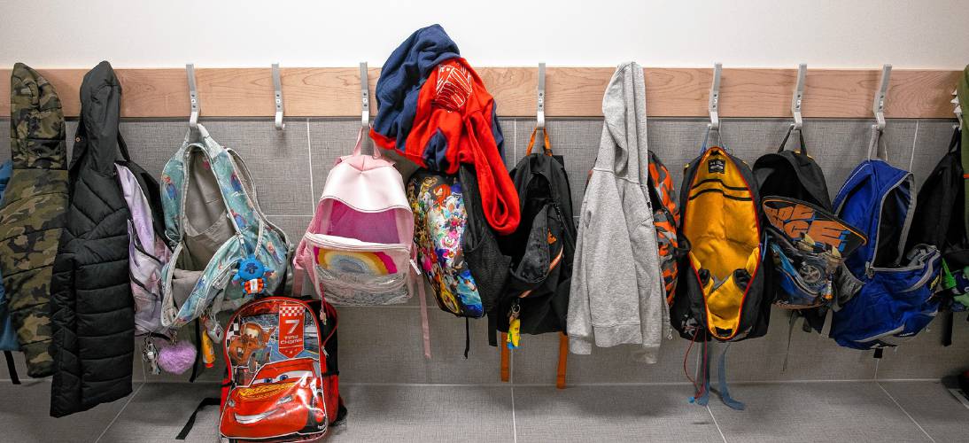 The studentâs backpacks and coats line the hallways of the Allenstown Community School on the first day of classes on Friday, May 3, 2024.