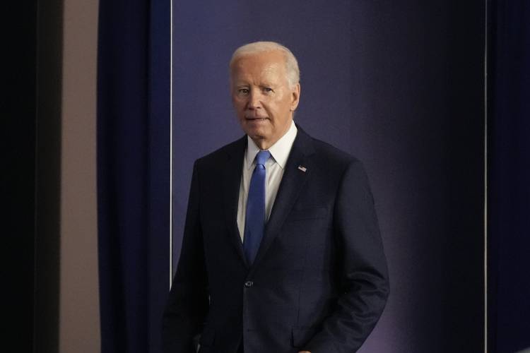 President Joe Biden walks across the stage to begin his news conference on Thursday, July 11, 2024, on the final day of the NATO summit in Washington. (AP Photo/Jacquelyn Martin)