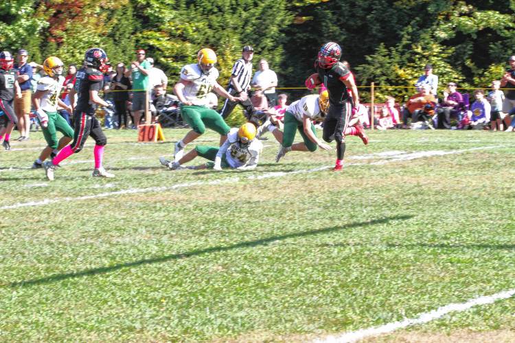 Hillsboro-Deering's Robert King (1) scampers into the end zone for a second quarter touchdown, leaving several Bishop Brady defenders in his wake, on Saturday, Oct. 5, 2024. King ran for 253 yards and four touchdowns, but it wasn't enough as H-D fell to Brady, 56-46, in H-D's first ever homecoming football game on its campus. 