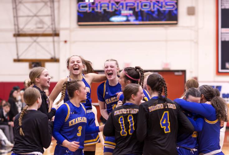 The Kearsarge girls’ basketball team celebrates at midcourt after defeating Hopkinton in last season’s Division III girls’ basketball championship on Feb. 24 at Keene State College. Kearsarge returns some key players.
