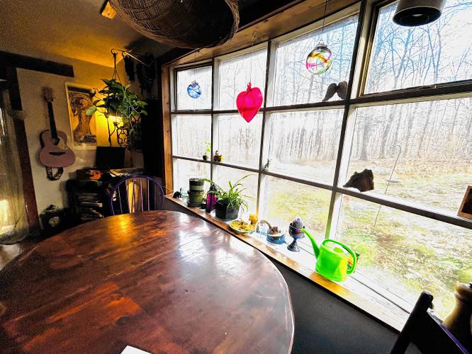 The kitchen table looks out over woodlands. 