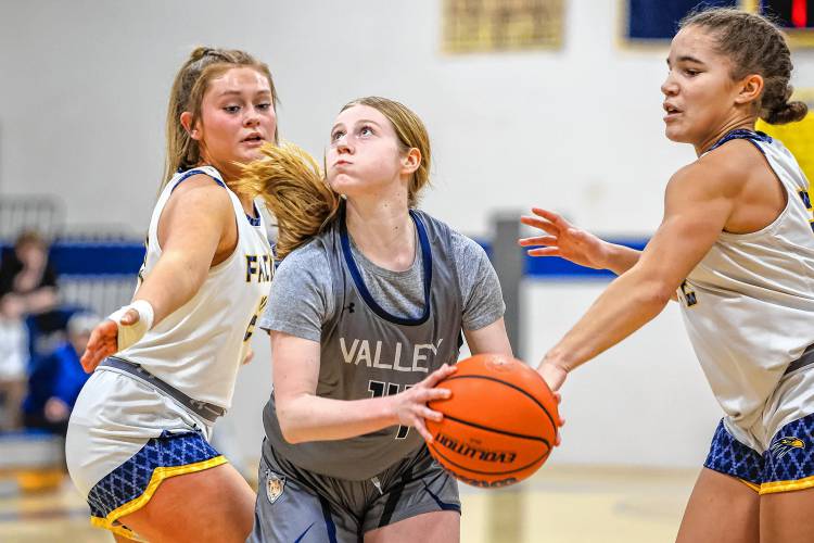 Merrimack Valley’s Emma McNutt looks towards the basket while being closely guarded by Bow’s Kate McGovern (left) and Peyton Vaughn (right). MV won 63-42 at Bow High School on Tuesday.