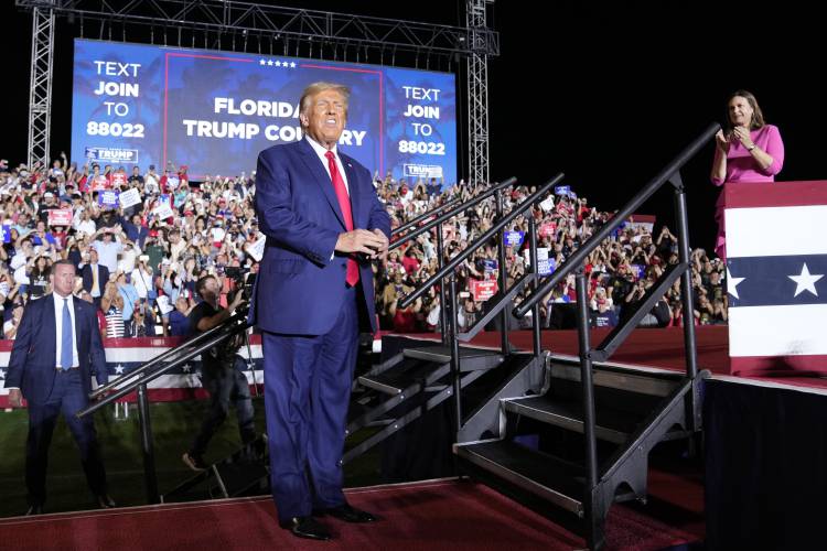 Former President Donald Trump arrives to speak at a campaign rally in Hialeah, Fla., Wednesday, Nov. 8, 2023. Arkansas Gov. Sarah Huckabee Sanders, stands right. (AP Photo/Lynne Sladky)
