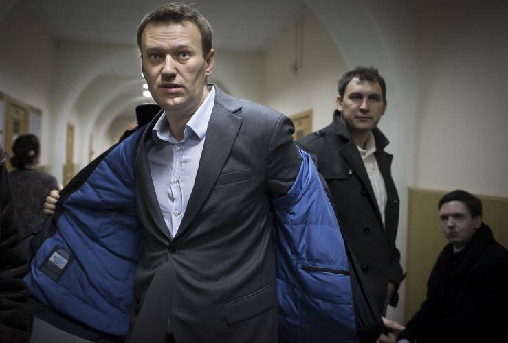 FILE - Russian opposition leader Alexei Navalny prepares to speak to journalists outside a courtroom in Moscow, Russia, on March 13, 2013 after his appeal against the country's top investigative agency was rejected. Alexei Navalny, the fiercest foe of Russian President Vladimir Putin who crusaded against official corruption and staged massive anti-Kremlin protests, died in prison Friday Feb. 16, 2024 Russia’s prison agency said. He was 47. (AP Photo/Alexander Zemlianichenko, File)