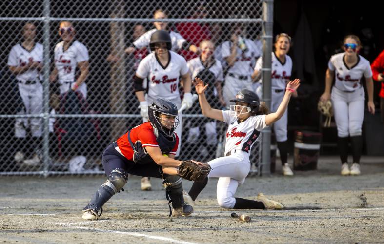 Coe-Brown righfielder Haile Comeau slides home safely as John Stark catcher Ruby Dykstra bobbles the ball during their Division II softball semifinal at Plymouth State University last June. Comeau is back as the Bears look to repeat last year’s championship victory.