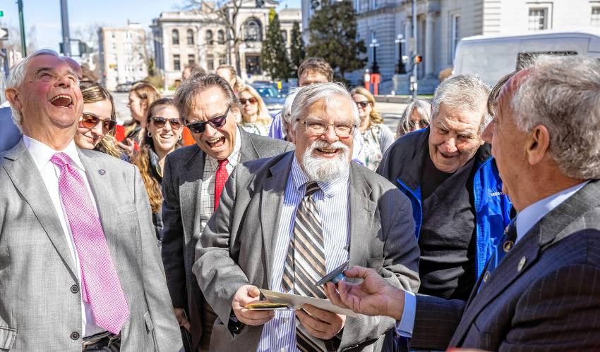 Senator Jeb Bradley and House Speaker Sherman Packard share a laugh as DOJ COO Terry Pfaff shows an item in the time capsule as they open it at the old DOJ and Mechanics Bank building on North State Street in Concord on Tuesday.