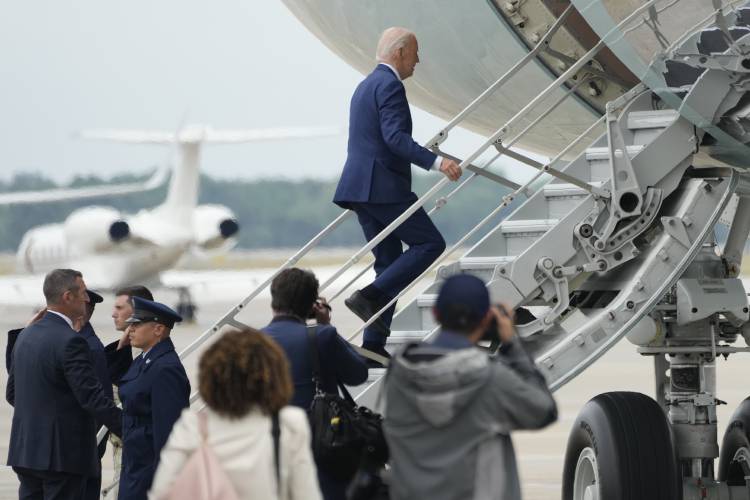 President Joe Biden boards Air Force One at Andrews Air Force Base, Md., en route to Detroit on Friday.