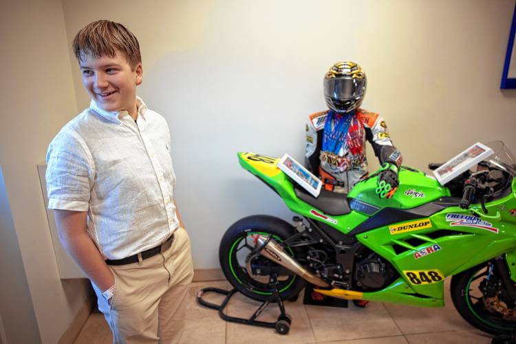 Cole Thompson stands with the bike he raced at Daytona that is now displayed at Freedom Cycle in Concord. Thompson has ascended from novice to amateur to compete in races across the region and country and aims to jump to expert races soon.