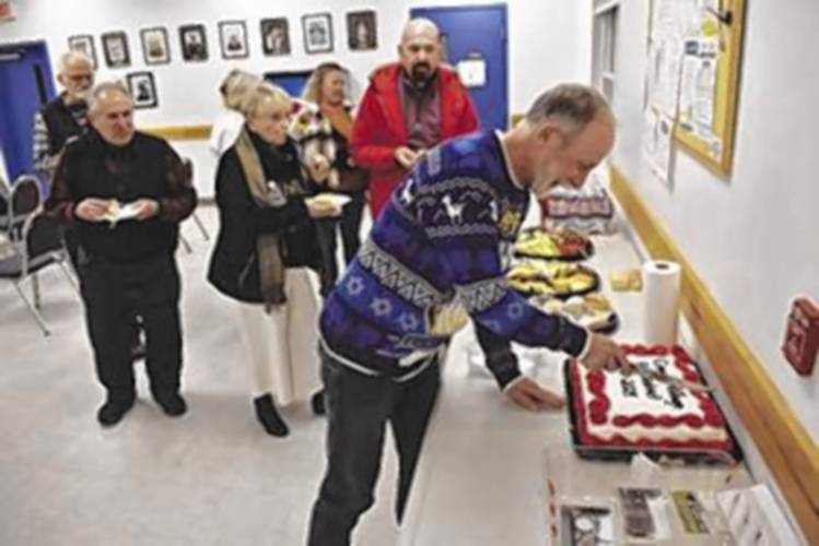 Conway Village Fire District Chair Steve Bamsey cuts a cake at the last Conway Village Fire District meeting last Thursday. The district dissolves into the town Jan. 1. Conway Village Fire District Chair Steve Bamsey cuts a cake at the last Conway Village Fire District meeting last Thursday. The district dissolves into the town Jan. 1.