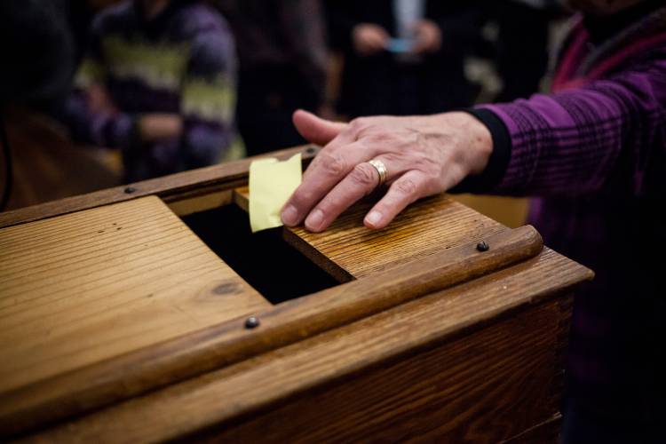 Warner residents cast their votes on a proposed municipal solar array during town meeting at Warner Town Hall on Wednesday, March 15, 2017. (ELIZABETH FRANTZ / Monitor staff)