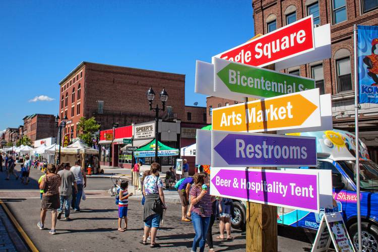 People walk along N. Main Street during opening day of Intown Concord’s Market Days Festival, Thursday, June 23, 2016. 