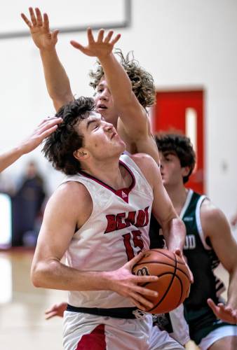 Coe-Brown forward Jack Matson fights under the basket against Kingswood on Tuesday night, February 27, 2024 in their opening round win.