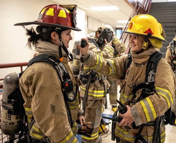 Addison “Nails” Bergeron and Lillian “Baggage Claim” O’Hara get ready to go through the obstacle course at their CRTC firefighter class at Concord High School on Thursday, March 7, 2024.