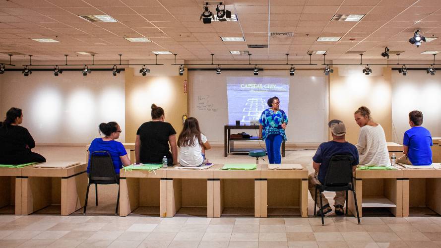 Stephanie Alicea talks with interested students and parents inside the former Bon-Ton space that she is transforming into the new Capital City Charter School at the Steeplegate Mall in Concord on July 24, 2018. Stephanie Alicea talks with interested students and parents inside the former Bon-Ton space that she is transforming into the new Capital City Charter School at the Steeplegate Mall in Concord on July 24, 2018.