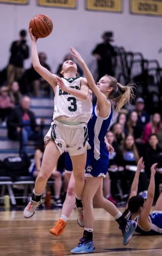 Hopkinton guard Shaylee Murdough (3) goes up for a shot against Winnisquam forward Triniti Carter  during the first half of last year’s Division III semifinal. Murdough was named the Division III Player of the Year and is back to lead the Hawks again this season.
