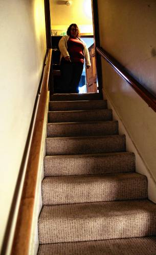 Nicole looks down the staircase in their home where she made sure that Arlen couldn't leave their home.