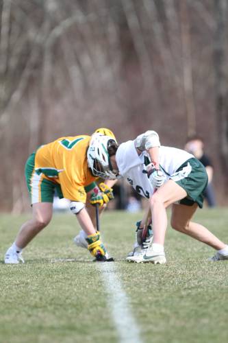 Bishop Brady senior Jason Doyle (left) faces off against Hopkinton senior Ozzie Rosenholm during Monday’s season-opening DIvision III boys’ lacrosse encounter in Hopkinton.