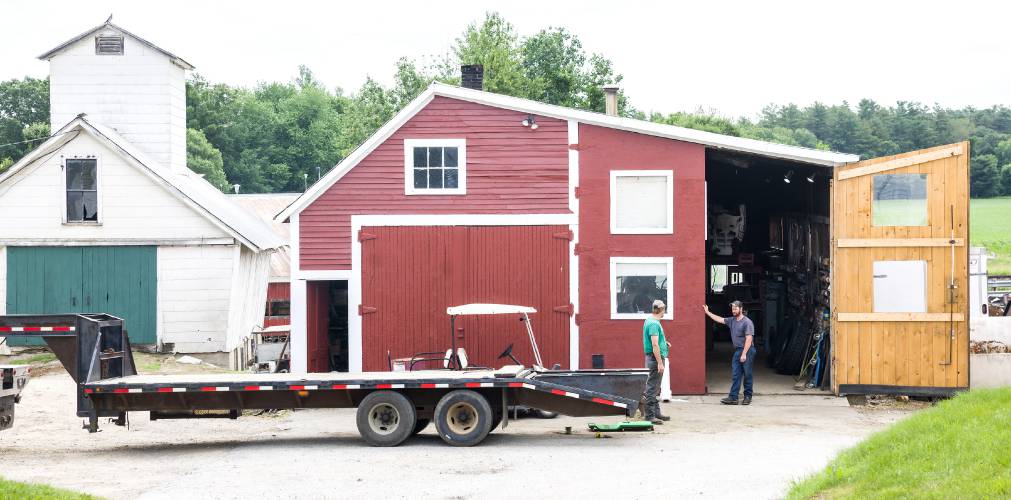 Brother Andy and Ryan Morrill talk in front of the repair shed at the farm in Penacook on June 26, 2025.
