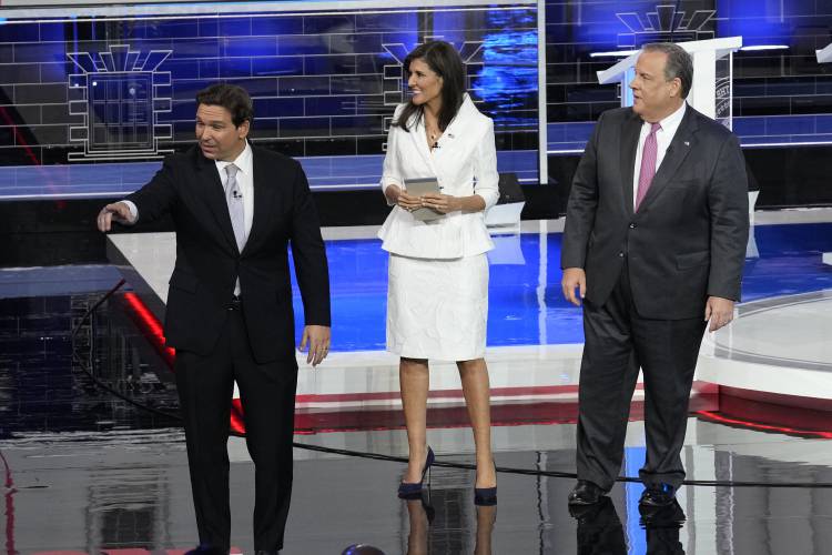 FILE - Republican presidential candidates Florida Gov. Ron DeSantis, former U.N. Ambassador Nikki Haley and former New Jersey Gov. Chris Christie walk on stage after a Republican presidential primary debate hosted by NBC News, Nov. 8, 2023, at the Adrienne Arsht Center for the Performing Arts of Miami-Dade County in Miami. (AP Photo/Rebecca Blackwell, File)
