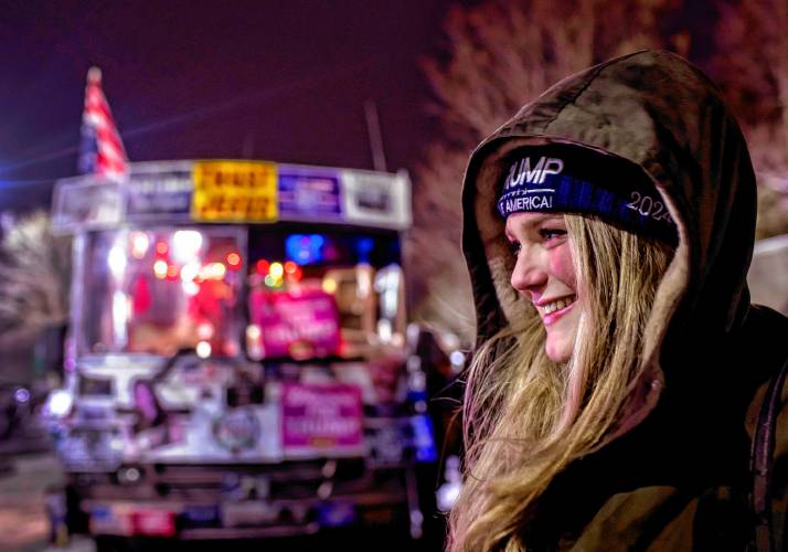 Kate Benner of Andover waits in line outside the Courtyard by Marriot in Concord to get in to see former President Donald Trump on Friday night, January 19, 2024.