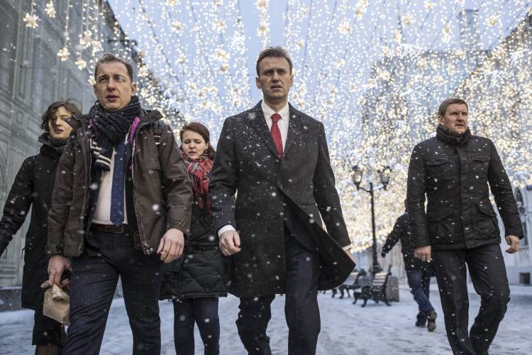 FILE - Russian opposition leader Alexei Navalny, who submitted endorsement papers necessary for his registration as a presidential candidate, center, heads to attend a meeting in the Russia's Central Election commission in Moscow, Russia on Dec. 25, 2017. Navalny, the fiercest foe of Russian President Vladimir Putin who crusaded against official corruption and staged massive anti-Kremlin protests, died in prison Friday Feb. 16, 2024 Russia’s prison agency said. He was 47. (AP...