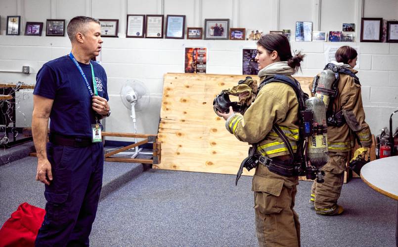Lt. Jim Duckworth of the Concord Fire Department talks with CRTC student Addison Bergeron before firefighter students run through an obstacle course at Concord High School on Thursday, March 7, 2024.