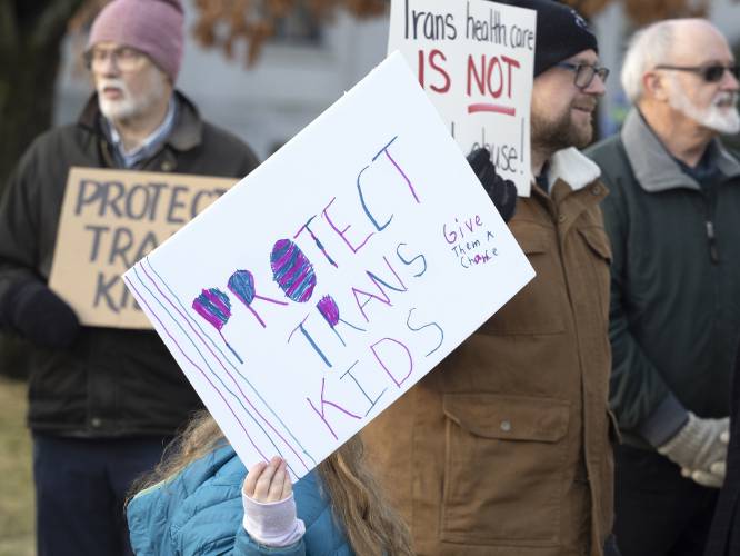 Protesters stand outside the State House on Wednesday morning, March 16, 2022 in opposition to HB 1180, that would add new gender-related language to New Hampshire’s birth records law.