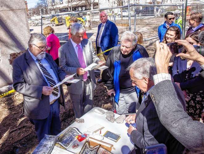 House Speaker Sherman Packard and Senator Jeb Bradley, along with Senator Lou D'Allesandro look over the items of the time capsule at the former DOJ building on North State Street in Concord on Tuesday, April 9, 2024.