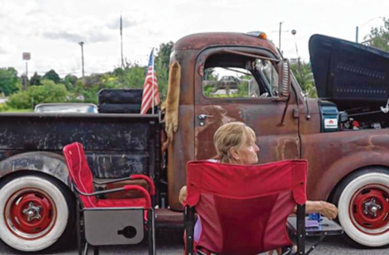 Brenda Patten sits in front of her ex-husband-turned-friend’s 1948 Dodge truck at Classic Car Cruise Night in the parking lot of the Tilt’n Diner in Tilton on Thursday evening.