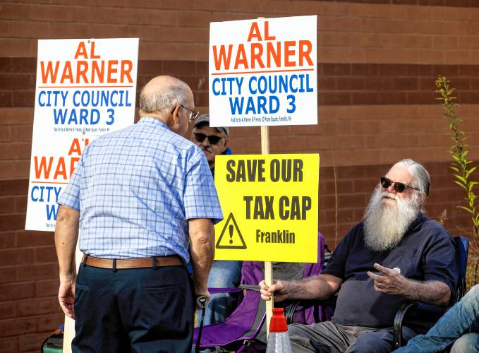 Al Warner, who is running for Ward 3 city council in Franklin, greets voters outside the Franklin Middle School on Tuesday, October 1, 2024.