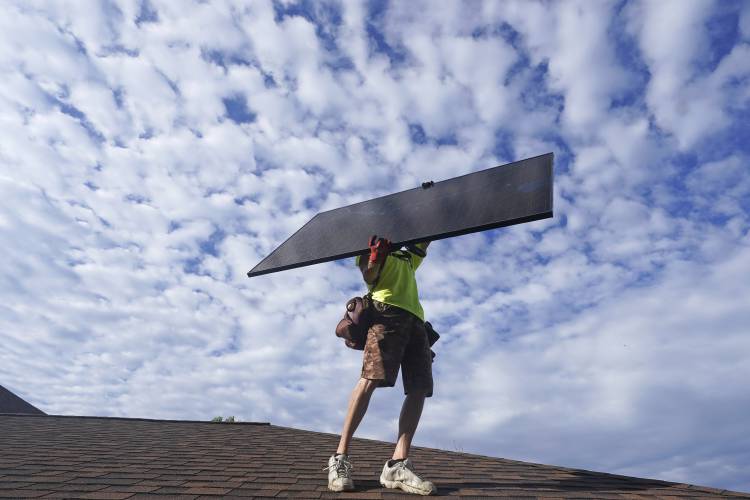 A workman from Power Shift Solar installs a solar panel Thursday, Aug. 11, 2022, in Salt Lake City. A workman from Power Shift Solar installs a solar panel Thursday, Aug. 11, 2022, in Salt Lake City.