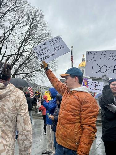Andrew Peyton, a 22-year-old from Manchester, protests in front of the New Hampshire State House and urges his members of Congress to 