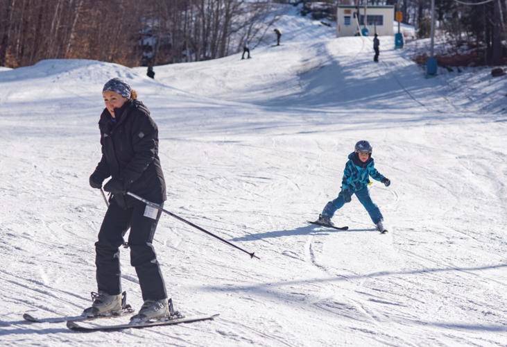 Mary Nolin, left, of Sanbornton, and her son Nolin Hibbard, 5, ski at the Veterans Memorial Ski Area in Franklin on Sunday afternoon. Nolin grew up in Stark, where she spent a lot of time learning to ski at Cannon Mountain, including during ski trips for her school gym class. She now takes her children to learn how to ski at The Vets. 