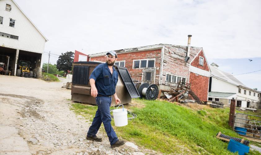 Kevin Morrill walks across the back yard of the Morrill Farm.