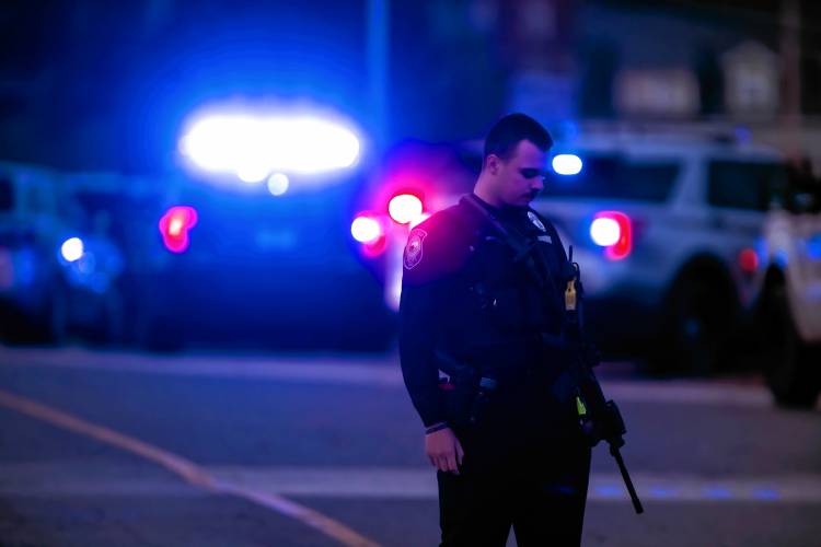 A Concord police officer stands outside the New Hampshire Hospital grounds after a shooting at the facility on Friday afternoon, November 17, 2023.