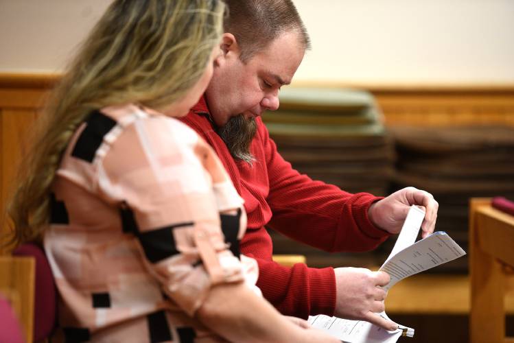 Newport school board member Tim Beard reads through court documents with his wife, Andrea, in Windsor Superior Court on Tuesday in White River Junction.
