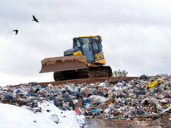 Conway public works employee Tim Shackford gets ready to dump dirt over the garbage in the city landfill on Jan. 18, 2023.