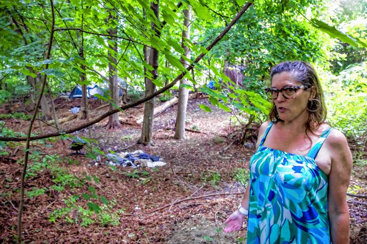 Robin Bach stands in her backyard property line where one of the homeless camps are located on June 19. Her children do not play in the backyard because of the camps. One camp is behind her property while another is behind her neighbor’s.
