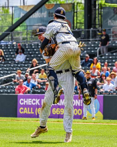 Bow catcher Owen Webber leaps into the arms of pitcher Sean Guerrette after the Falcons beat Souhegan, 13-3, to claim the Division II state championship on June 8. Webber, an All-State First Team honoree, is back behind the plate for Bow this spring.