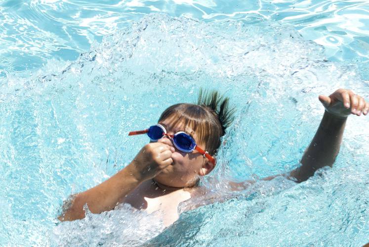 Hayden Demeritt, 11, jumps into the deep end of the pool at Keach Park on Thursday, July 6, 2023. Demeritt was part of a swim camp that meets every day from 10-11:30.