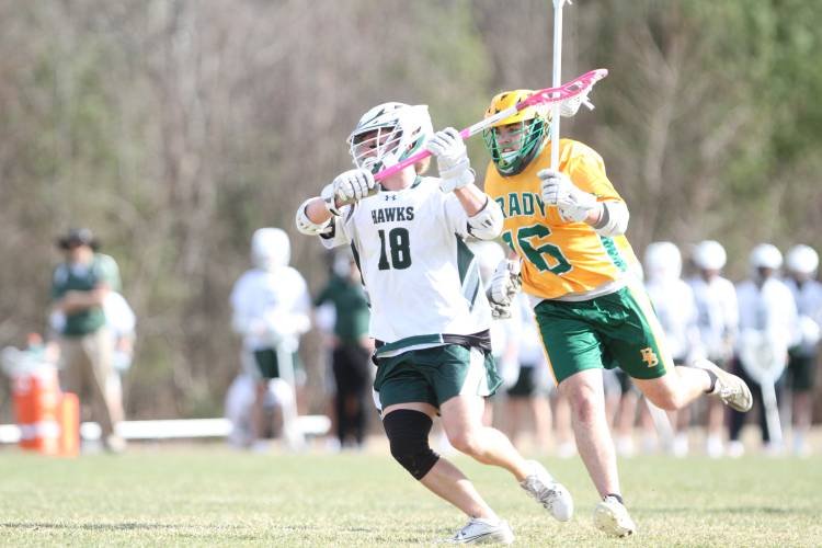 Hopkinton's junior captain and midfielder, Shane Smith (18), fires off a shot against Bishop Brady in the season opener.