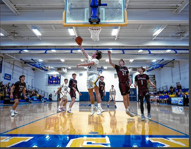 Senior captain Eddie Kinzer attempts a layup for Kearsarge during the Cougars matchup with Fall Mountain on Jan. 8.