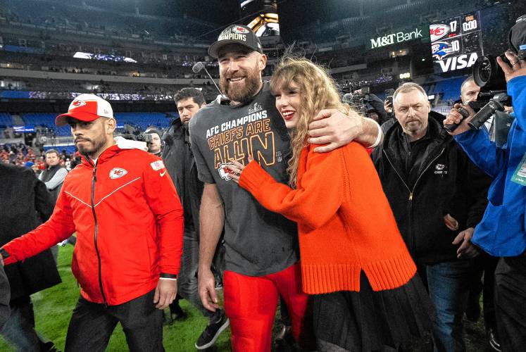 Kansas City Chiefs tight end Travis Kelce and Taylor Swift walk together after an AFC Championship NFL football game between the Chiefs and the Baltimore Ravens on Jan. 28.