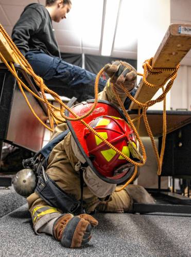 Addison “Nails” Bergeron leads the group through the obstacle course at their CRTC firefighter class at Concord High School on Thursday, March 7, 2024.