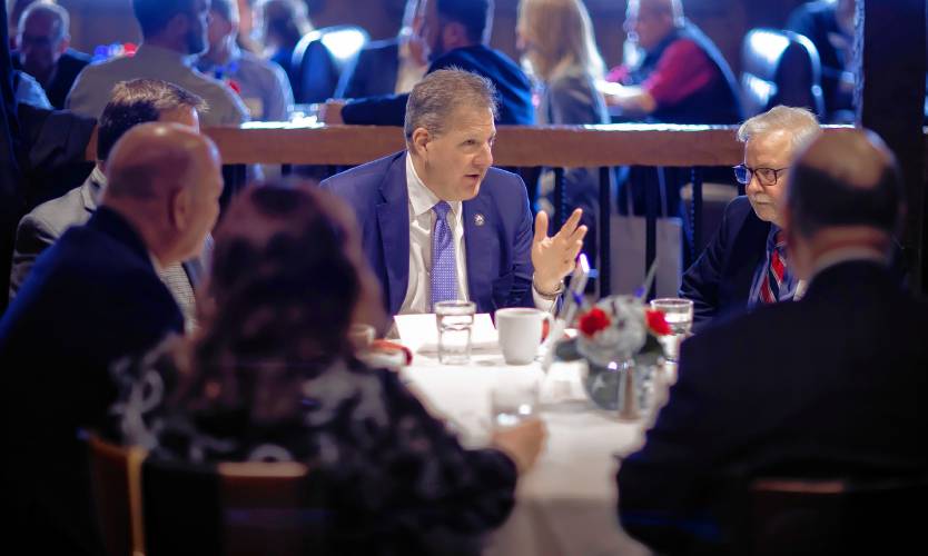 New Hampshire Gov. Chris Sununu speaks with Chamber President Tim Sink and others before his last Concord Chamber of Commerce annual State of the State luncheon at the Red Blazer on Tuesday.