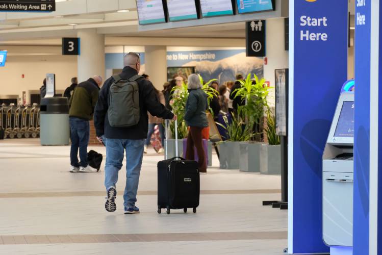 A passenger walks through the Manchester-Boston Regional Airport. A passenger walks through the Manchester-Boston Regional Airport.