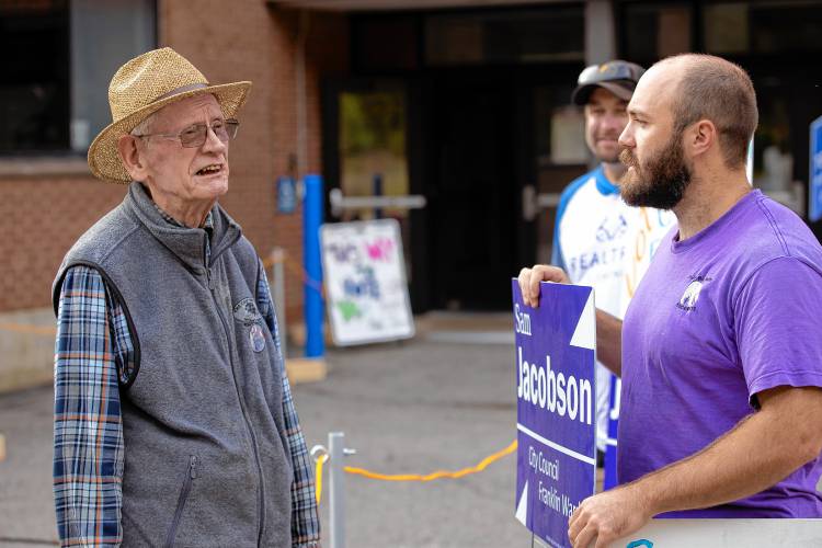 Sam Jacobson, running for Franklin city council in Ward 2, talks with voter Karl Grant, 87, after he voted at the Franklin High School on Tuesday, October 1, 2024.
