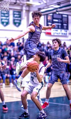 Merrimack Valley guard Aiden Gray goes up to block a shot as Pembroke Academy guard Brady Boisvert goes up for a fake during the first half of Monday’s game, an 81-40 win for the Spartans.