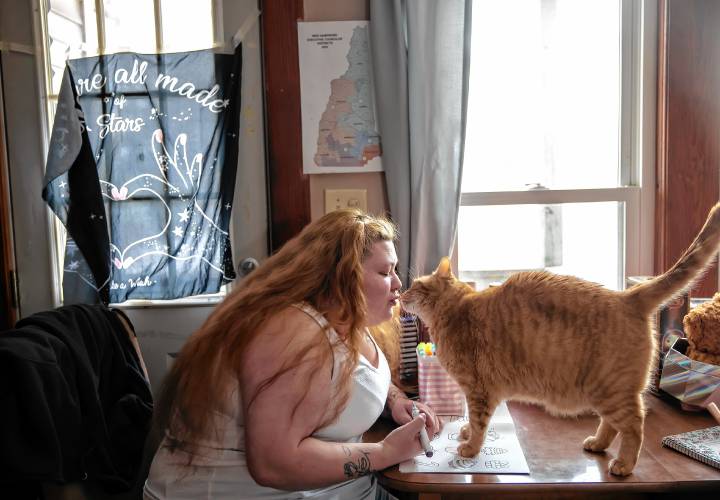 Brie Lamarche with her cat, Blaize, at her apartment in Rochester on March 4.